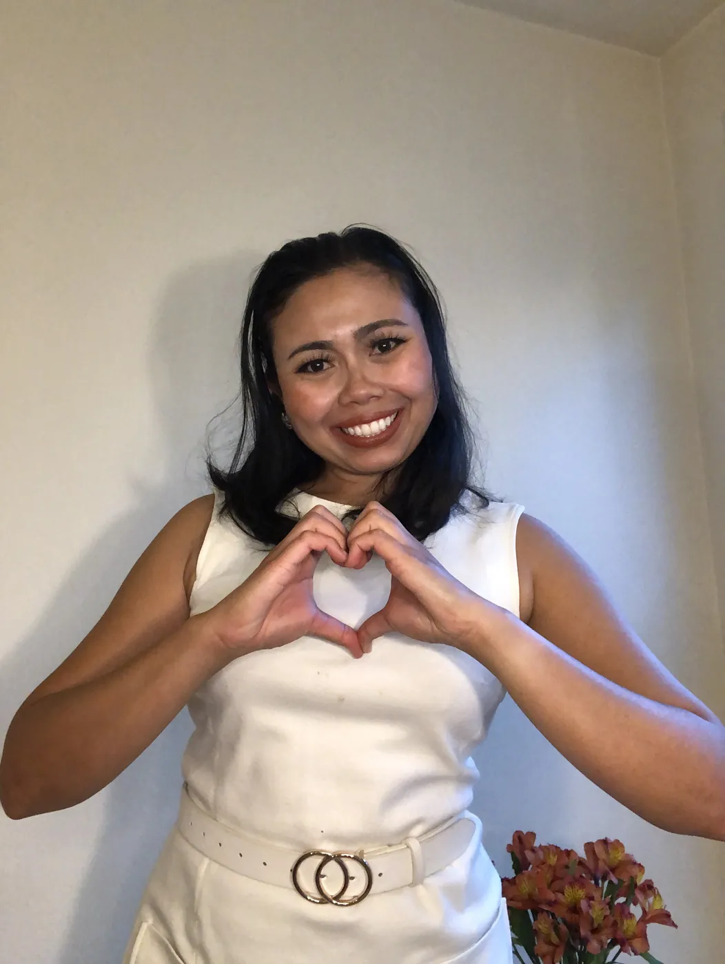 Krittaya making a heart shape with her hands
